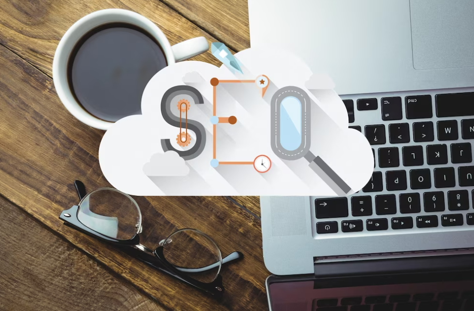 seo word on the cloud, coffee, glasses and laptop on wooden desk