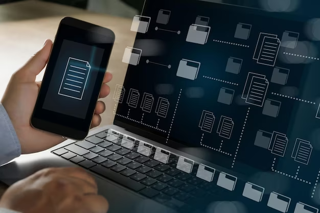 A man holds a phone in his hands, next to a laptop with folders concept