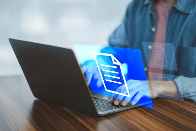 A man sits at a laptop next to an element with a digital document