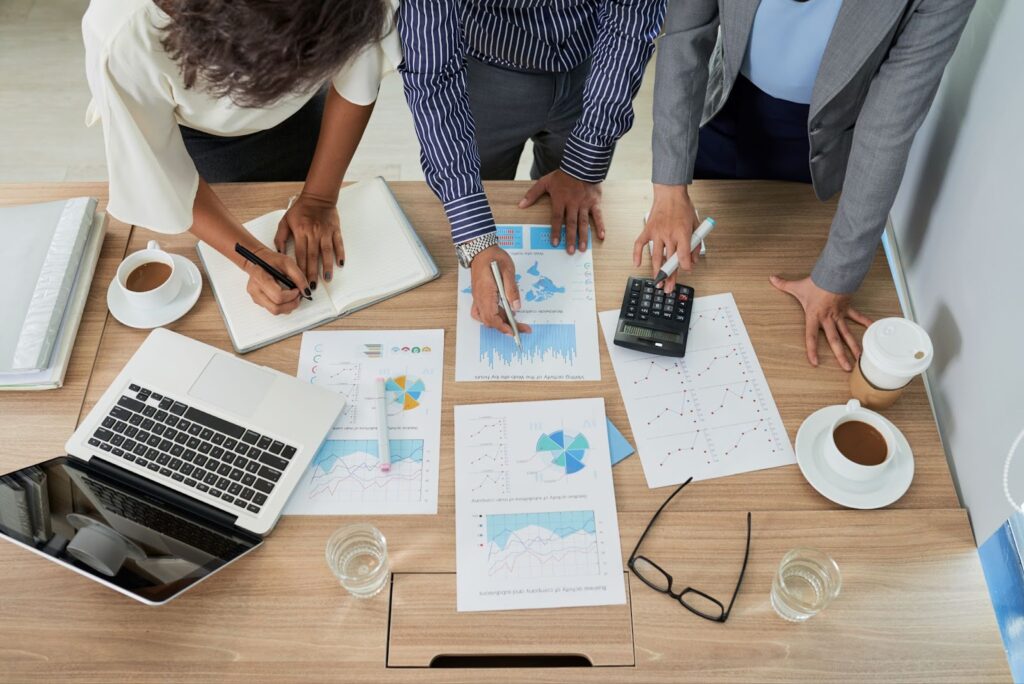 Top view of three employees discussing a project