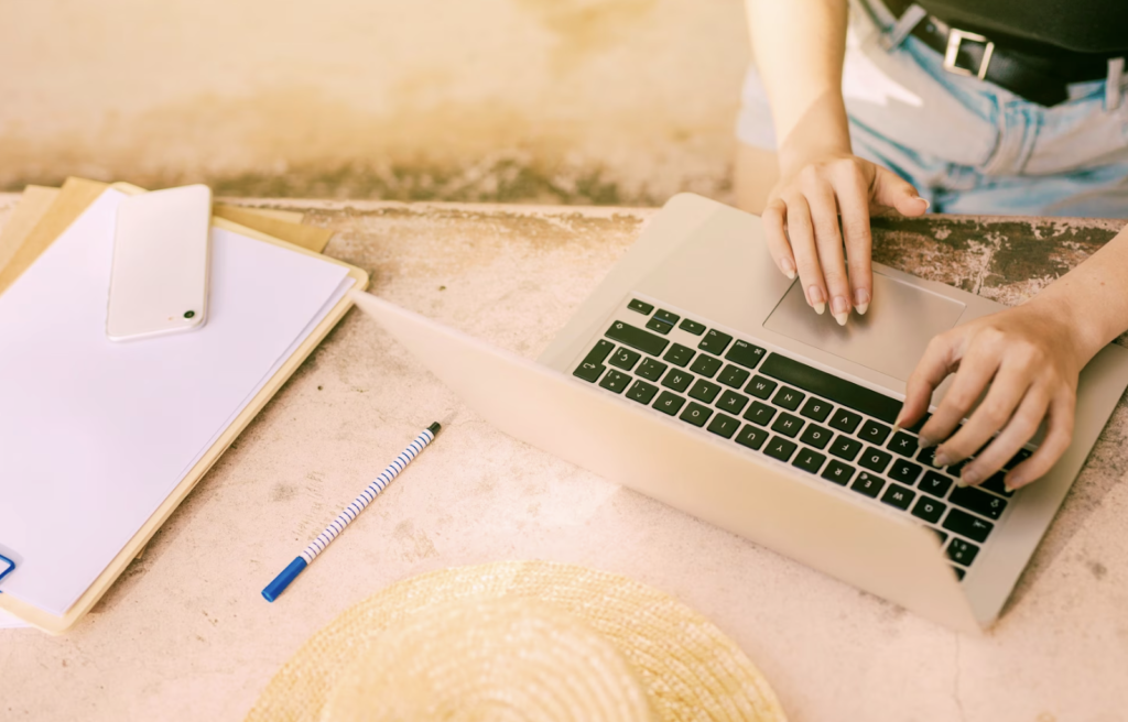 A woman typing on a laptop