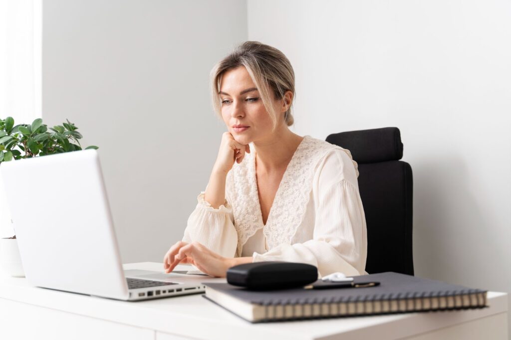 A woman working focused on her computer