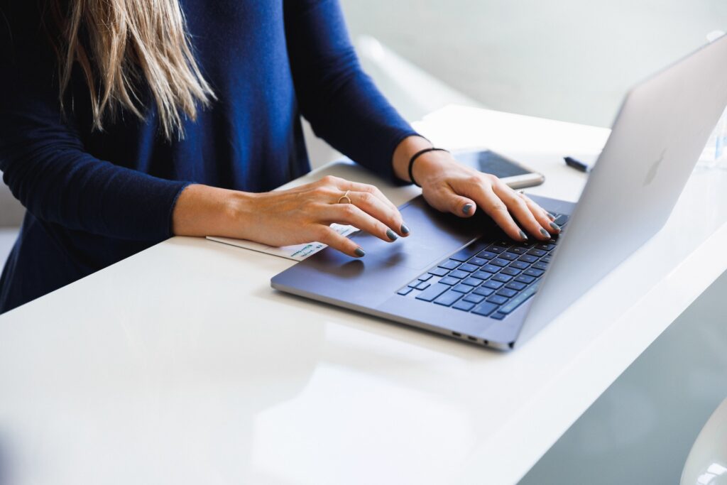 woman typing on laptop